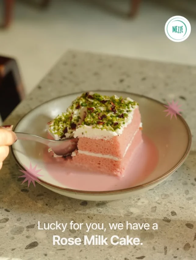 Mezze's pink rose milk cake topped with pistachios