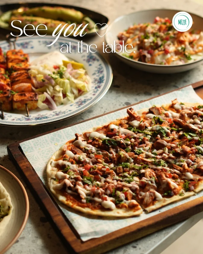 Flatbread and sharing plates on a table at Mezze